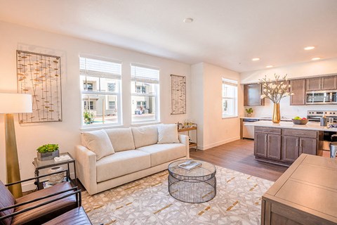 a living room with a couch and a kitchen