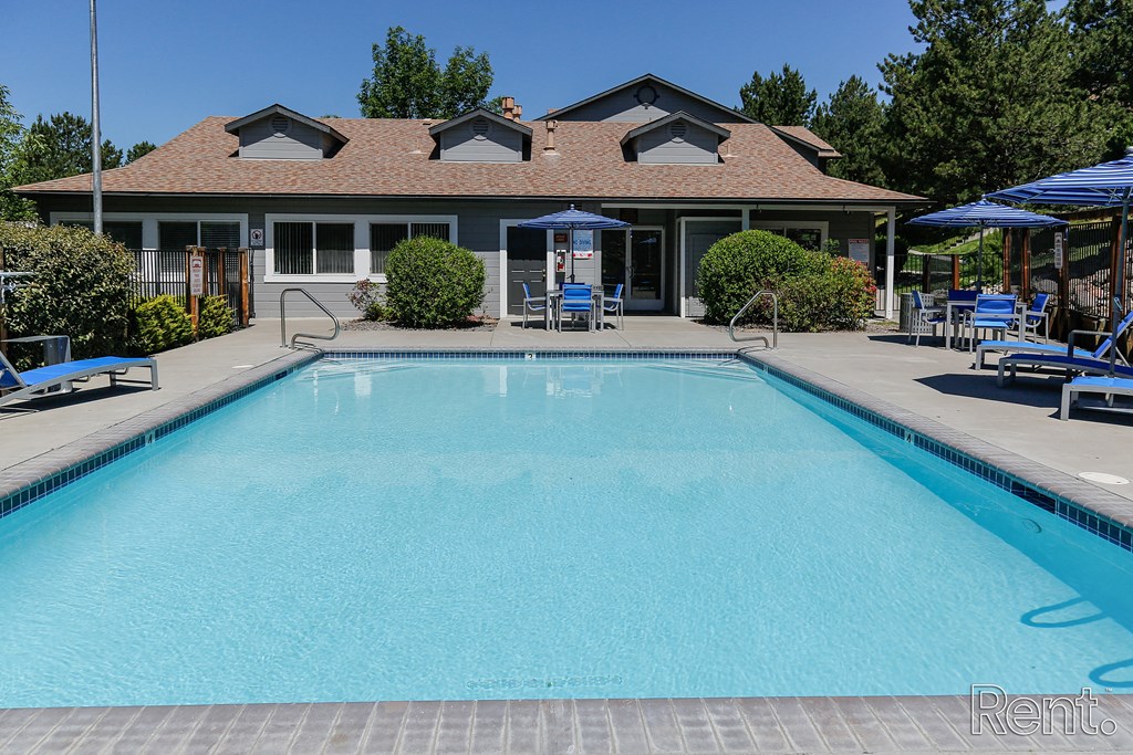 a swimming pool with a building in the background