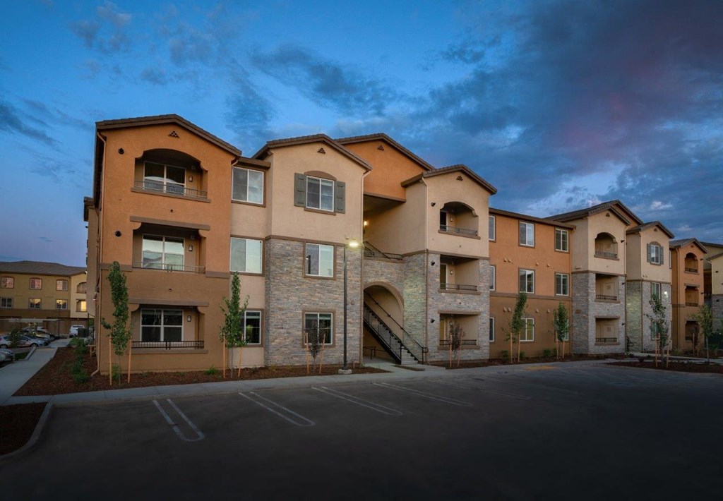 Apartments in Roseville CA - Exterior View of the Apartment Building Showing Expansive Community and Parking Spaces