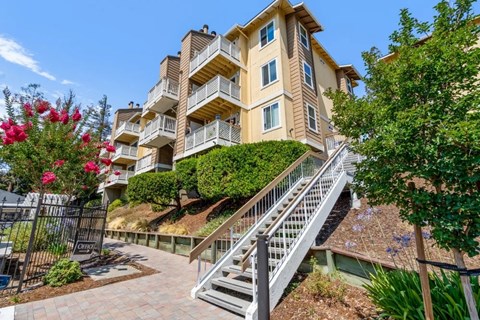 A multi-story building with a staircase leading to the entrance.