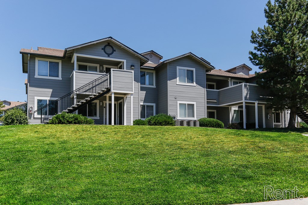 a large house on a hill with a grassy area in front of it