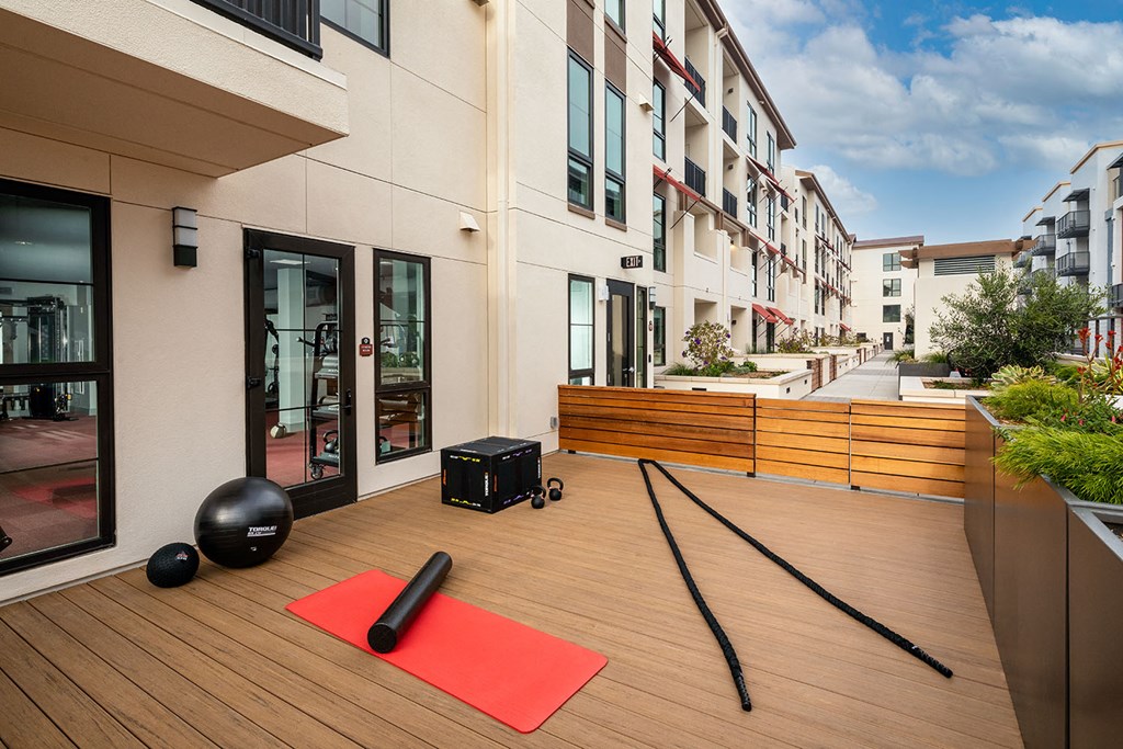 Yoga mat with equipment on a deck