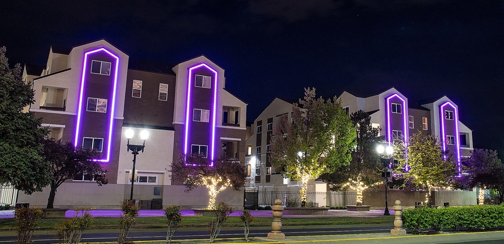 Sparks, NV Apartments For Rent - Fountainhouse at Victorian Square - Exterior View Of Apartment Homes. Building Is Surrounded By Lush Landscaping And A View Of The Outdoor Lounge