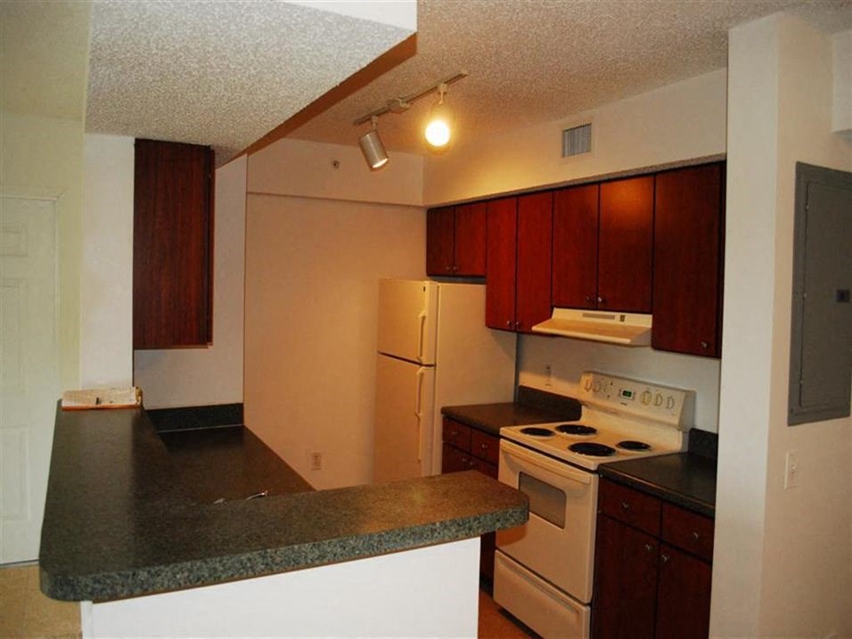 Kitchen with appliances at Alhambra Cove, Florida