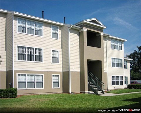 A residential building with a staircase leading to the entrance.