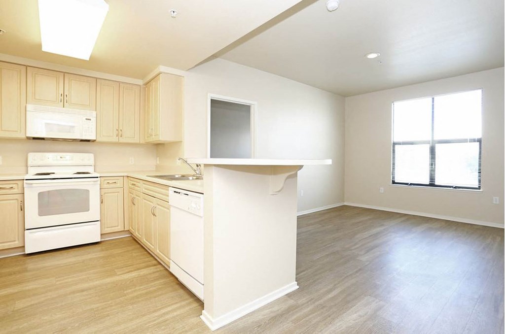 a kitchen with a white stove top oven next to a window at K Street Flats, Berkeley California