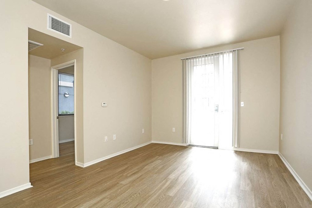 a bedroom with a sliding glass door and hardwood floors at K Street Flats, California