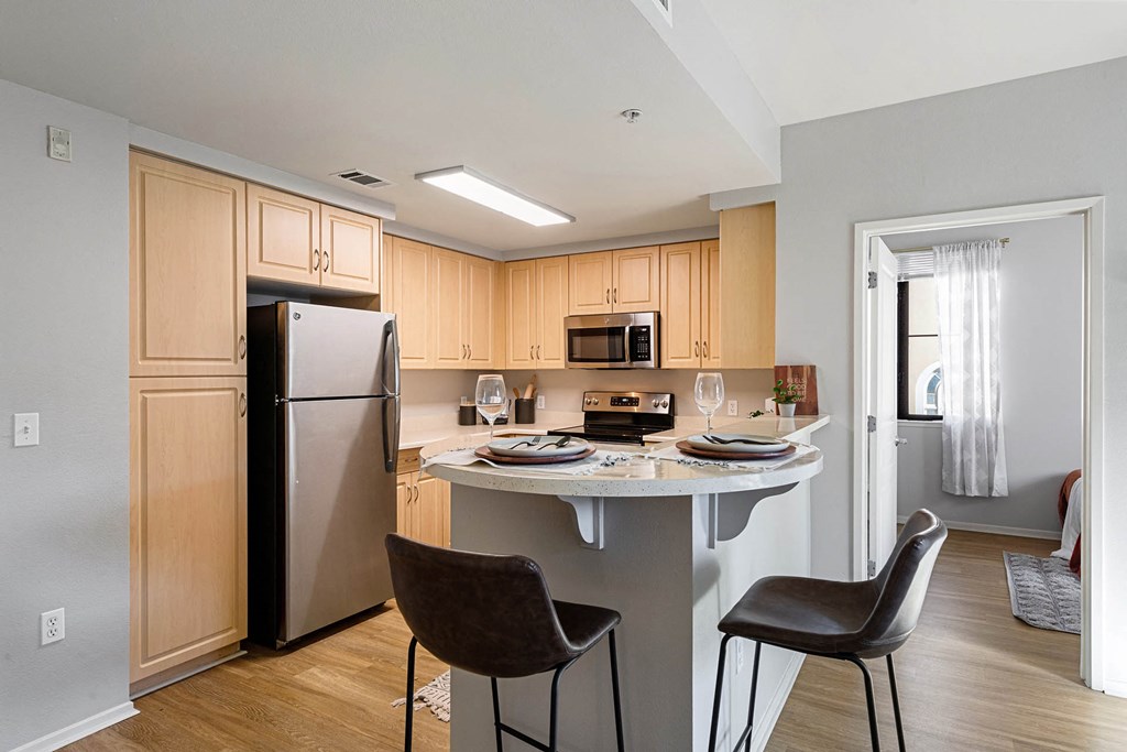 a kitchen with an island and two chairs at K Street Flats, Berkeley