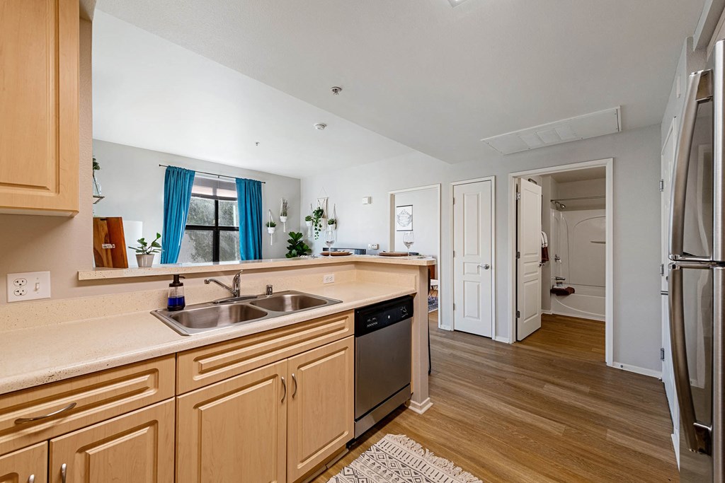 a kitchen with wooden cabinets and a stainless steel sink at K Street Flats, California