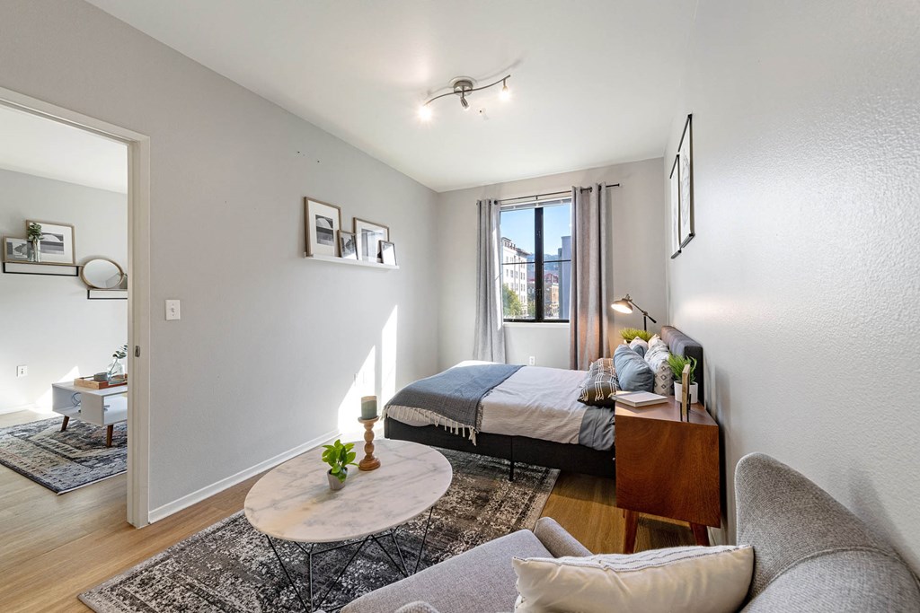 a bedroom with a bed and a table in a room at K Street Flats, Berkeley, 94704