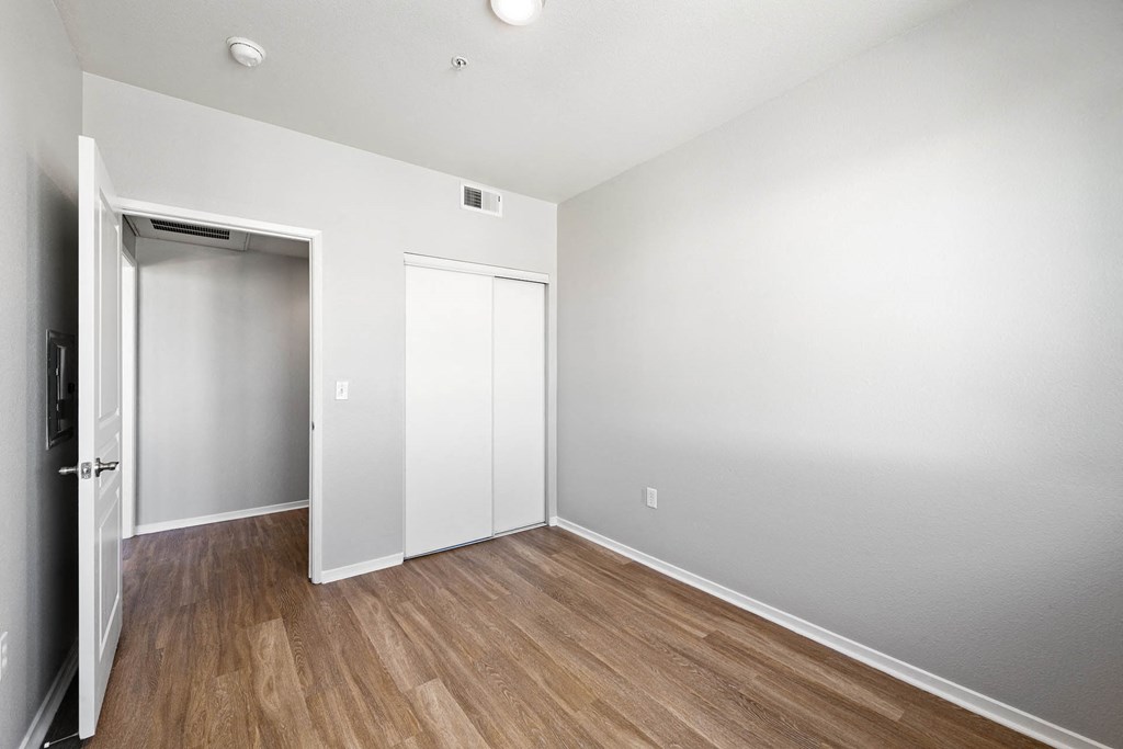 a bedroom with white walls and hardwood floors a bedroom with white walls and hardwood floors at K Street Flats, Berkeley California