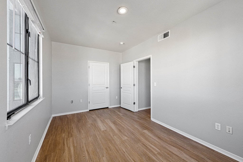 a bedroom with hardwood floors and grey walls at K Street Flats, Berkeley, 94704