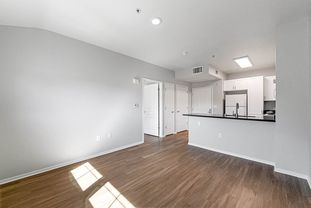 a bedroom with a medium sized bed and a kitchen in the background at K Street Flats, California