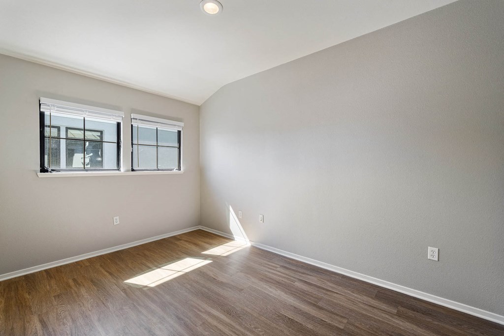a bedroom with hardwood floors and grey walls at K Street Flats, Berkeley, 94704
