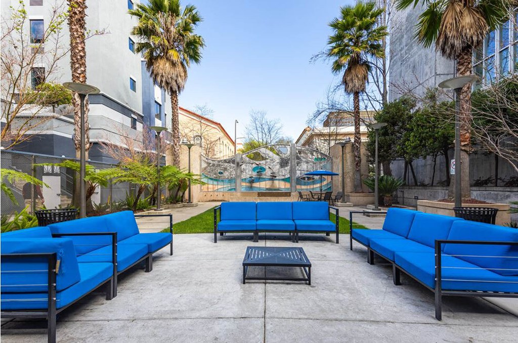 a courtyard with blue couches and a coffee table a courtyard with blue couches and a coffee table at K Street Flats, Berkeley, 94704