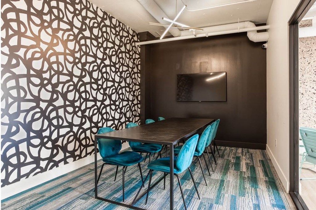 a conference room with a table and chairs and a tv on the wall a conference room with a table and chairs and a tv on the wall at K Street Flats, Berkeley, 94704