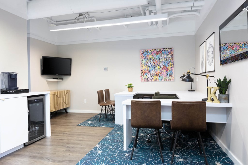 a dining area with a table and chairs and a television on the wall at K Street Flats, Berkeley, 94704 