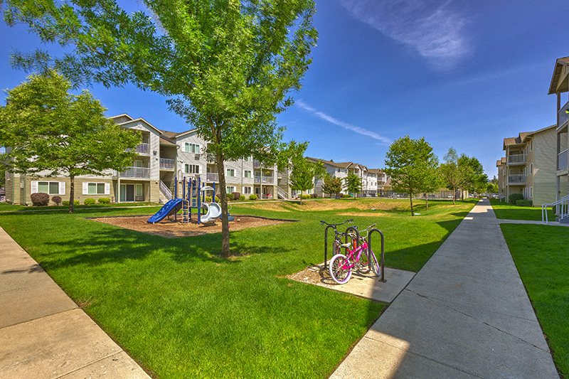 Lush Grounds & Playground | Falls Creek Apartments in Couer D'Alene, ID 83815