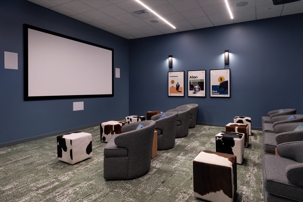 Theater Room With Projector Screen, Couch Chairs, And Footstool at FARM BY VINTAGE, MILL CREEK