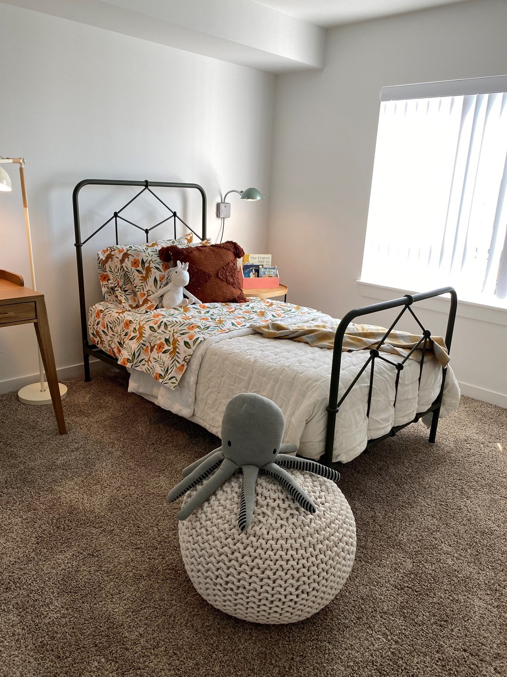 a bedroom with a bed and a rocking chair in front of it at FARM BY VINTAGE, MILL CREEK, WA 98012