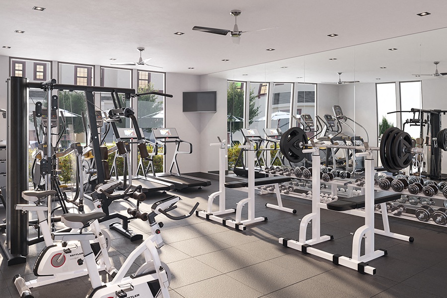 a gym with cardio equipment and a flat screen tv