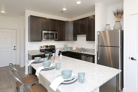 a kitchen with stainless steel appliances and a white counter top