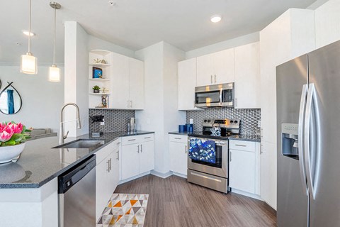 a kitchen with stainless steel appliances and white cabinets