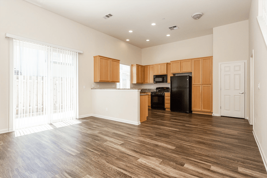 Townhomes in Rocklin CA - The Terraces at Stanford Ranch - Spacious Living Room with Wood-Style Flooring and Direct Access to the Kitchen and Private Patio