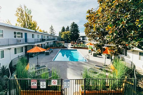 View of pool with lounge chairs 