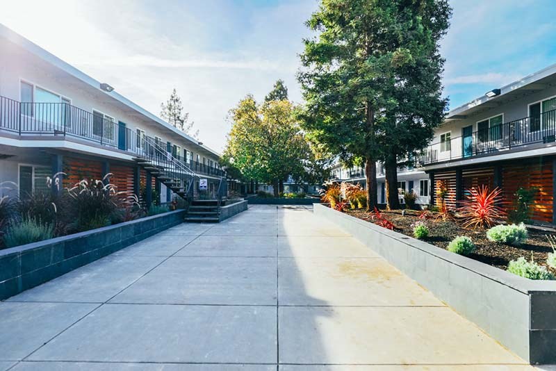 Fairfield, CA Apartments - Magnolia Terrace - A Courtyard With Apartment Buildings On Either Side And Surrounded By Beautiful Landscaping