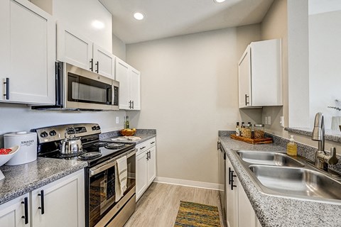a kitchen with stainless steel appliances and granite counter tops