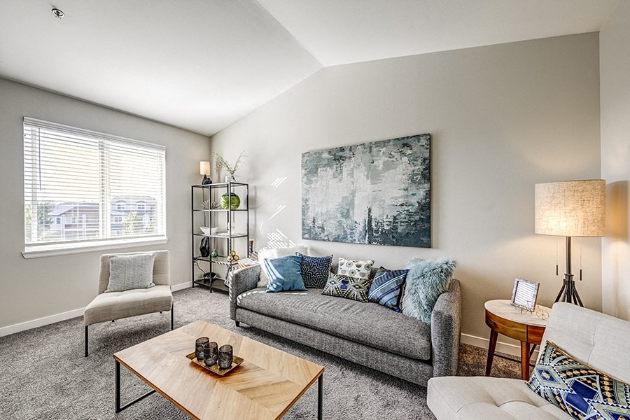 Living Room with Wall-to-wall Carpet, Large Window, Couch, Chairs, and Coffee Table at BELLA SONOMA, Fife, WA