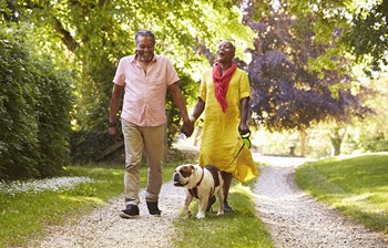 Senior couple walking their dog outside - Photo Gallery 3