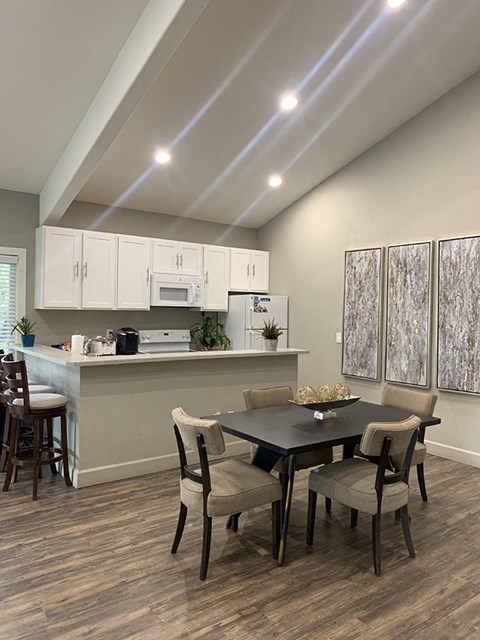 a kitchen and dining room with a table and chairs
