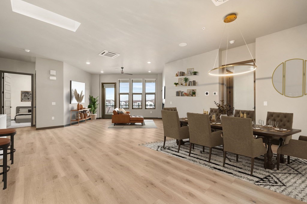 a living room and dining room with hardwood floors and white walls