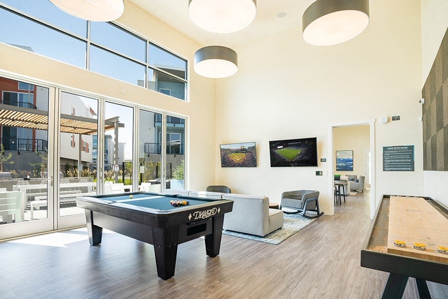 Apartments for Rent in Folsom, CA - Hub Apartments - Pool Table, Shuffle Board, Seating Area, and Floor-to-Ceiling Windows