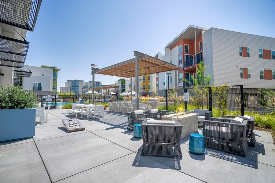Outside seating by fire pit and corn hole game