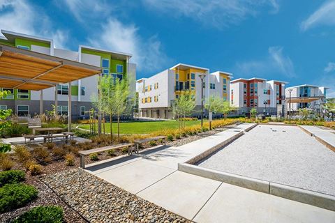 One Bedroom apartments in Folsom CA - Hub Apartments - Bocceball Court Next to Grass Area wit Landscaping, and Seating Area