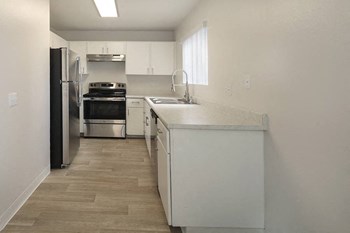 Kitchen with appliances and wood floors - Photo Gallery 3