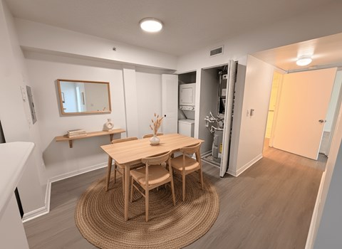 A dining room with a wooden table and chairs.