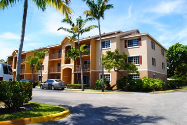 Exterior of building with trees Hibiscus Pointe Apartments in Miami Florida
