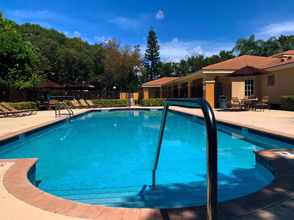Pool with lounge chairs at Hibiscus Pointe, Florida
