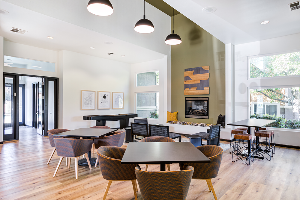 A modern dining room with a large table and chairs.
