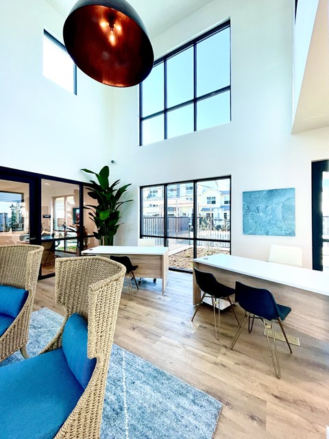 a dining room with a table and chairs and a large window