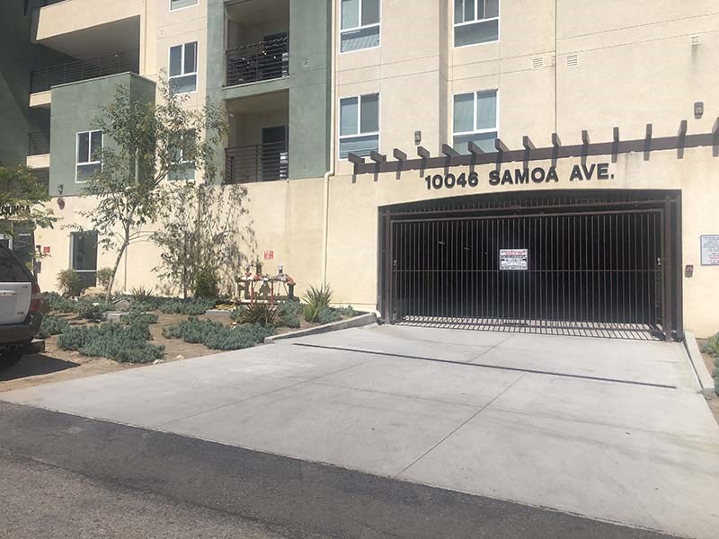 Exterior view of entrance to community with landscape 
