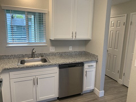 Updated kitchen interiors with white cabinets and counter tops