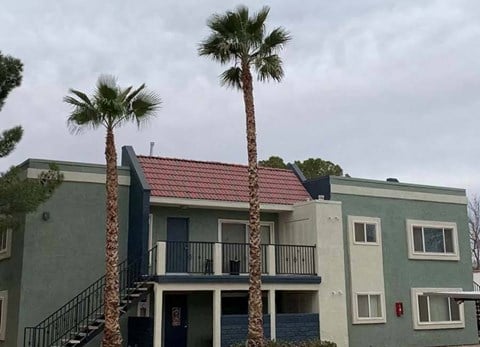 a house with two palm trees in front of it