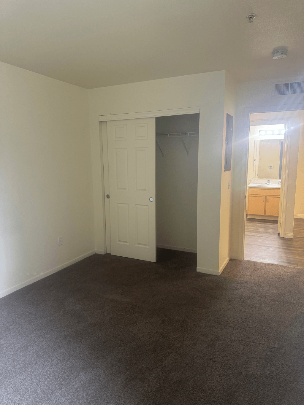 an empty living room with a closet and a bathroom at VINTAGE AT CITI VISTA, Reno