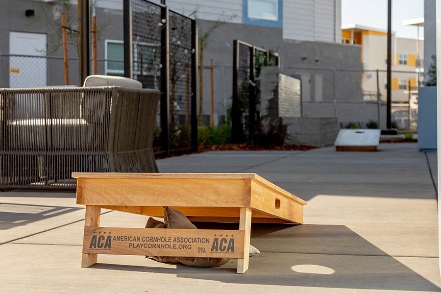 Corn hole next to buildings