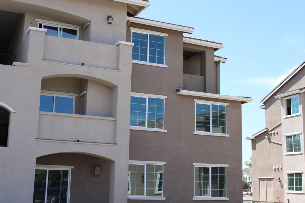 A multi-story residential building with balconies and windows.
